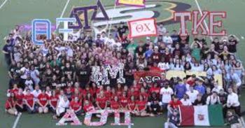 Large group of students posing on a football field